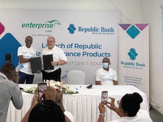 Keli Gadzekpo (right), Group CEO, Enterprise Group, and Farid Antar (left), MD, Republic Bank exchanging the signed agreement